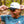 Man wearing a cap with an upside down UFFDA logo in a forest setting