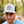 Person wearing a cap with a Minnesota logo in a forest setting